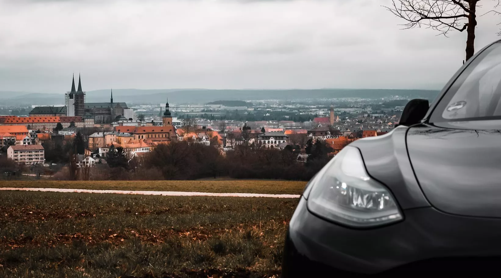 Tesla Model 3 mit Blick über Bamberg, Standort der Fin-E Vermietung